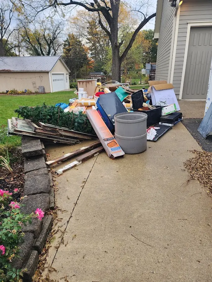 Dumpster being loaded with debris for 12 Yard Dumpster Rental in Worland